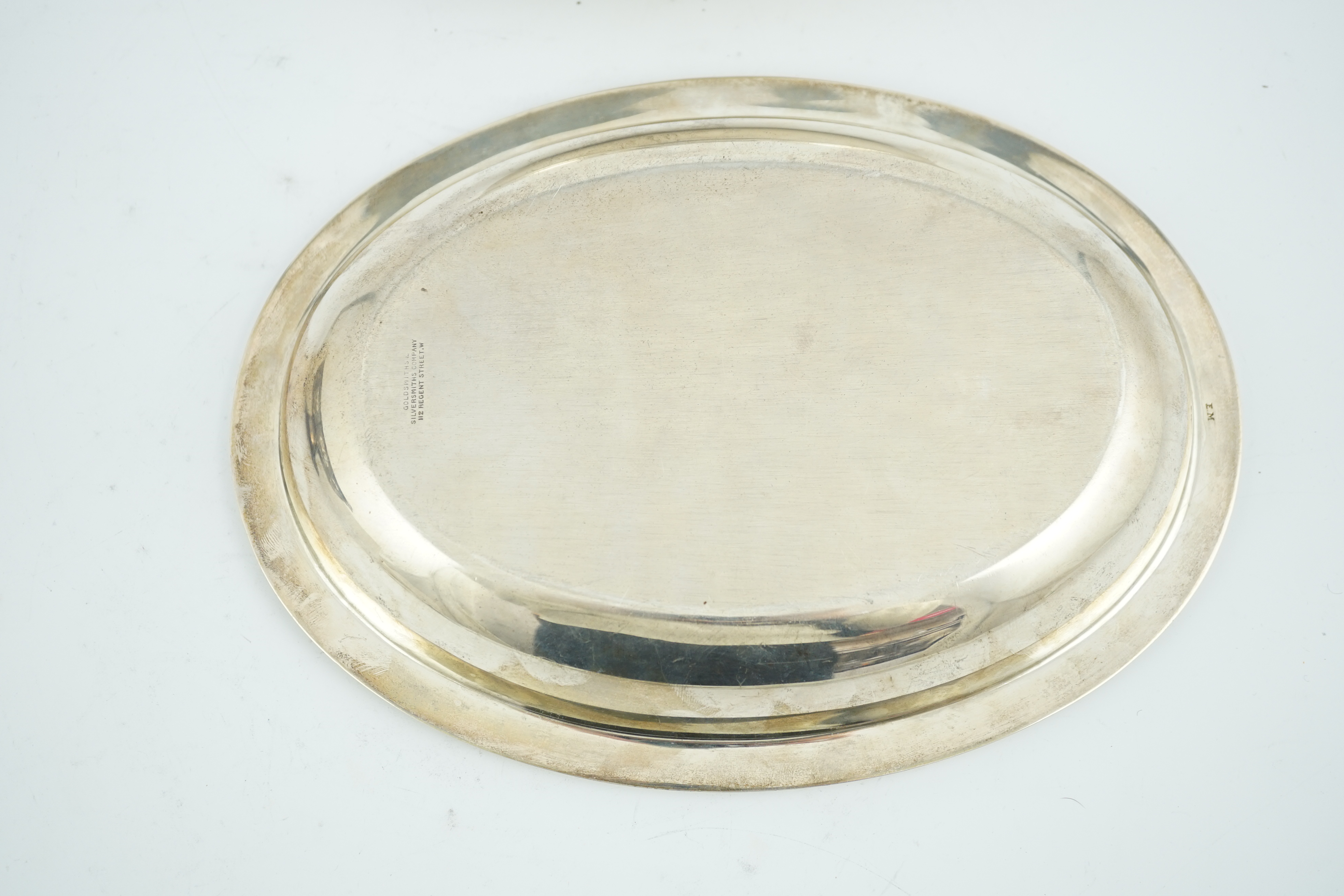 An Edwardian silver oval entreé dish and cover, lacking handle, by Goldsmiths & Silversmiths Co Ltd